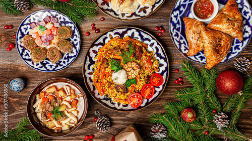 Traditional Uzbek oriental cuisine. Uzbek family table from different dishes for the New Year holiday. The background image is a top view