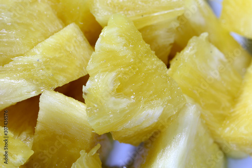 Close up slice pineapple background texture in white dish. Slide and piece of fresh fruit.