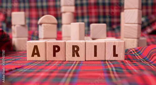 Word "April" written with wooden blocks