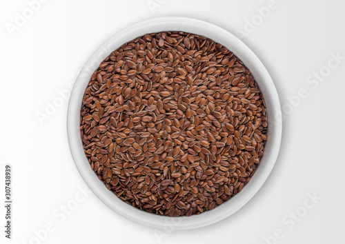 White bowl of raw natural organic linseed flax-seed on white background.