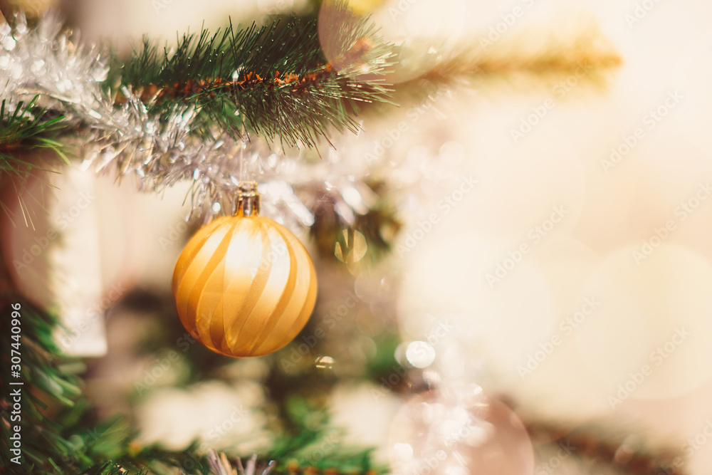Shiny Christmas golden ball hanging on pine branches, winter holiday xmas theme, Happy New Year Shiny Christmas golden ball hanging on pine branches, winter holiday xmas theme, Happy New Year