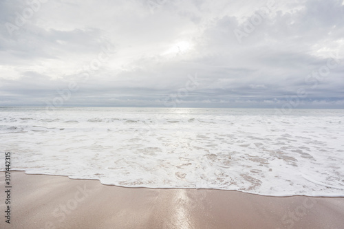 Fototapeta Naklejka Na Ścianę i Meble -  Ocean, sea, sand beach with black clouds on horizon. Zen picture (France-Vendée-Les Sables-d'Olonne)