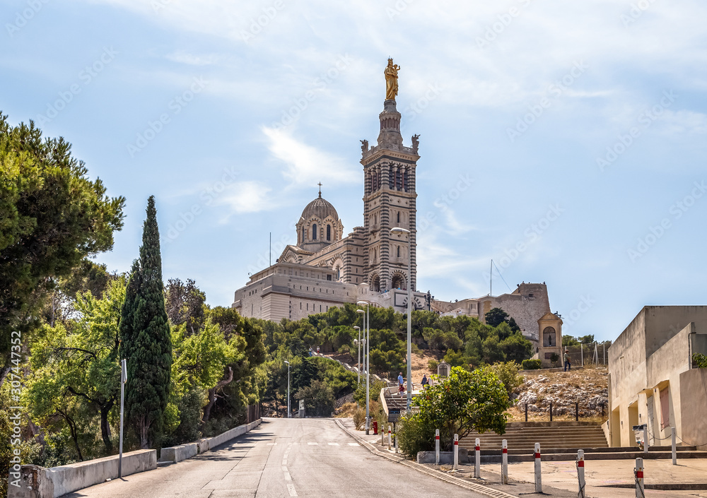 Basilica of Notre Dame de la Garde in Marseille, France, landmark of the city. Empty road leading to the cathedral. 