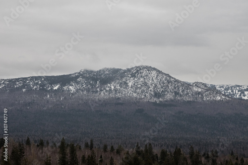 mighty snow covered mountains. winter in the natural park of Taganay. mountain range with high peaks. natural landscape. Background for your layout with free space for text.