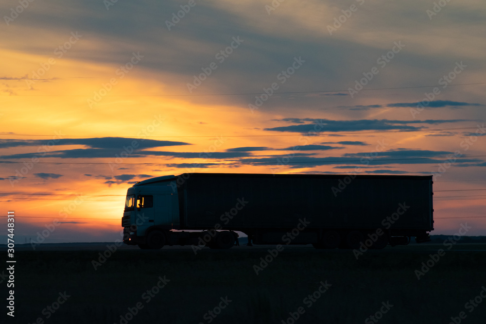 Truck on highway at sunset Truck on highway at sunset