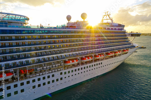 Boom in cruising with luxury cruise ship liner in port of Nassau, Bahamas during Caribbean cruise and sunset sunrise photo