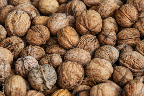 walnuts, unpeeled greek nuts, harvest of walnuts, walnuts closeup, background with walnuts,organic delicious nuts. healthy snack. © bukhta79