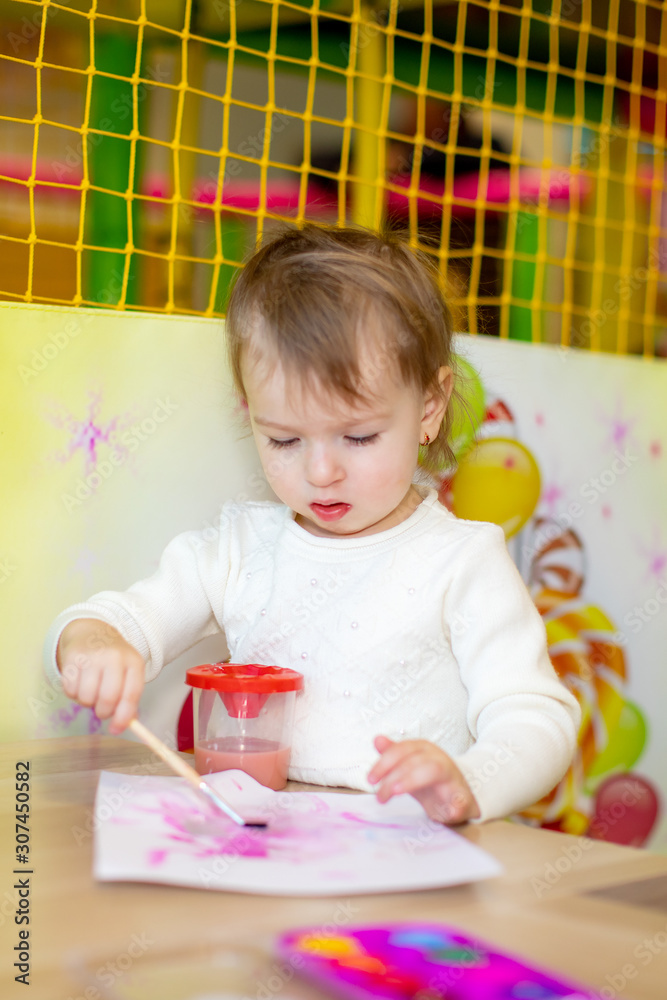 little girl playing in kindergarten or at home in the nursery little girl playing in kindergarten or at home in the nursery
