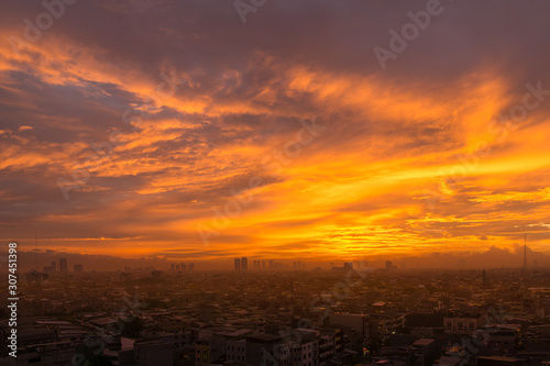 sunset over the city © Fanyanto