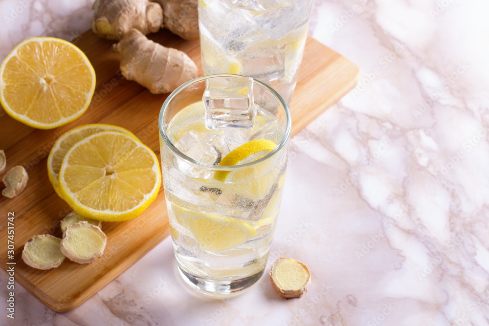 A glass of ginger water on marble table. Detox drink.