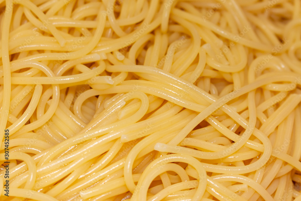 a portion of cooked spaghetti in closeup a portion of cooked spaghetti in closeup