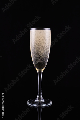 glass with white wine champagne on a black background