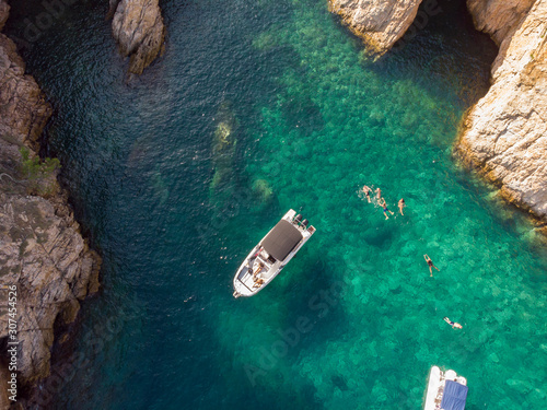 People swimming and enjoying a lagoon in Costa Brava, Spain photo