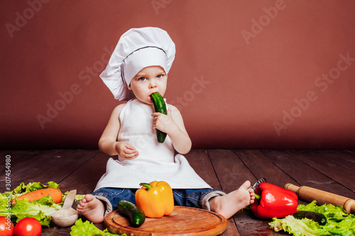 little boy Cook carrots, peppers, tomatoes, lettuce, photo