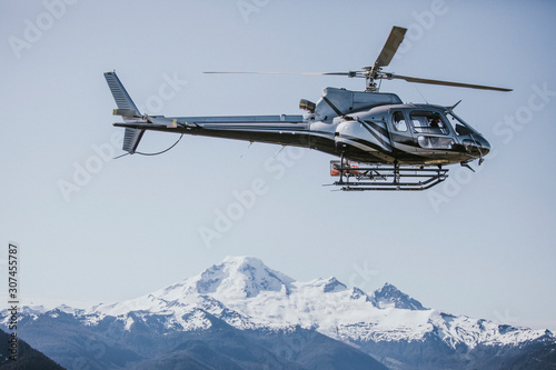 Helicopter flying over Mount Baker, Washington photo