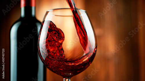 Detail of pouring red wine into glass photo