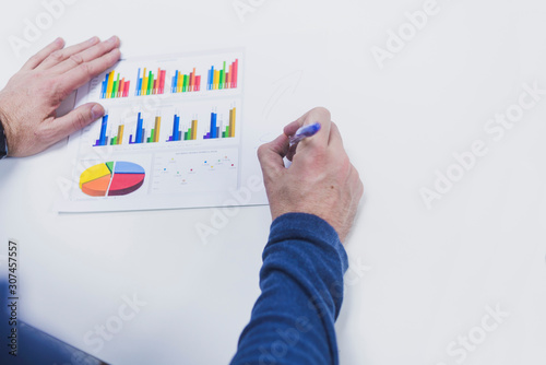 Overhead view of a hand writing in a chart photo