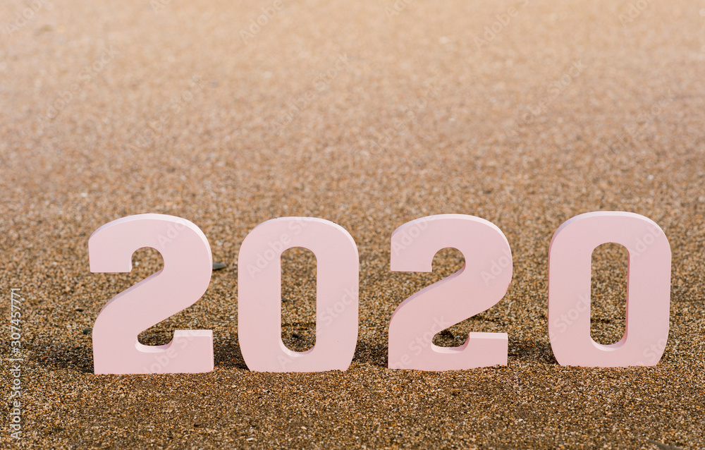 Creative inspiration concepts 2020 with pink text number with beach sand background. Business resolution, ideas of action plans. Shades of brown