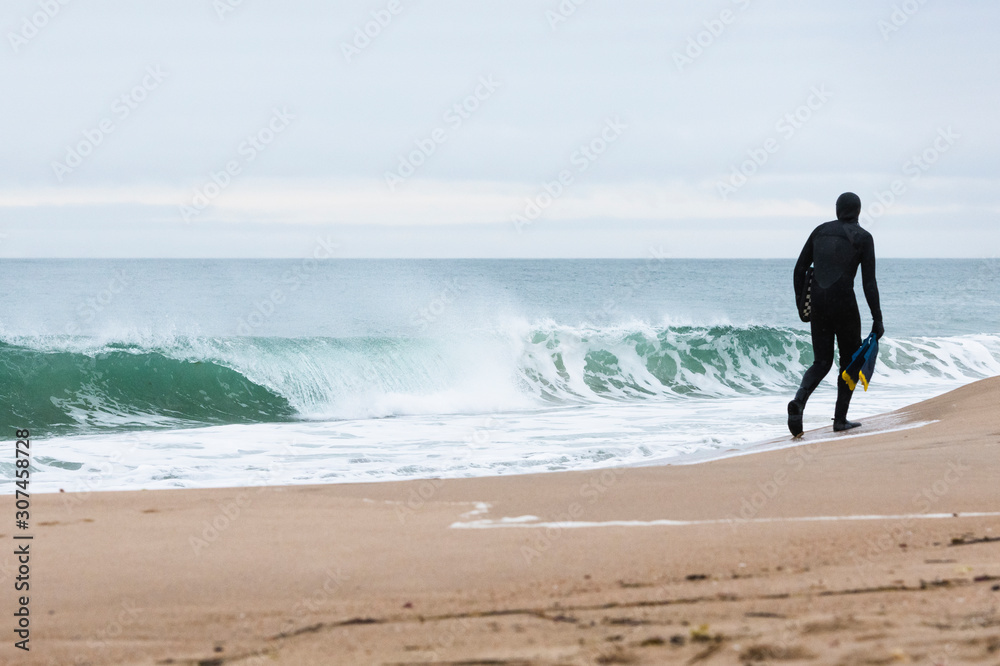 Getting ready to swim winter waves at the beach