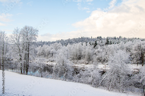 View to river Gauja in Gauja National Park with lot of snow and blue sky in December in Sigulda in Latvia © Laura Kezbere