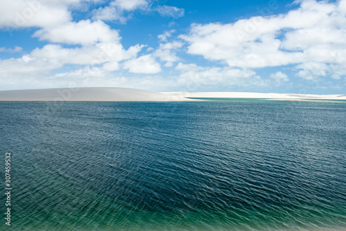 A huge green lake in the middle of Lencois Maranhenses National Park photo