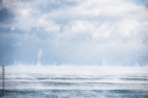 Sea smoke on a historically arctic cold day with winter waves photo