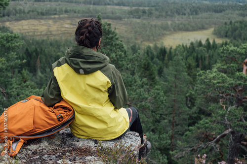 Woman sitting on rock photo