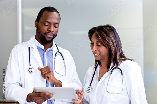 Two doctors going over reports on a tablet photo