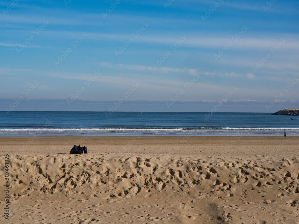 Beach landscape with dunes with footsteps and horizon line in Laredo, Spain Beach landscape with dunes with footsteps and horizon line in Laredo, Spain
