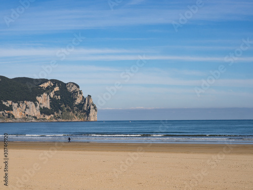 Beach landscape with horizon line and blue sky in Laredo, Spain