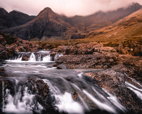 Fototapeta Naklejka Na Ścianę i Meble -  Fairy Pools waterfall in the Isle of Skye, Scotland located next to Glen brittle in the Scottish Highlands. Natural magical place with vivid colors and crystal clear blue pools on the river.