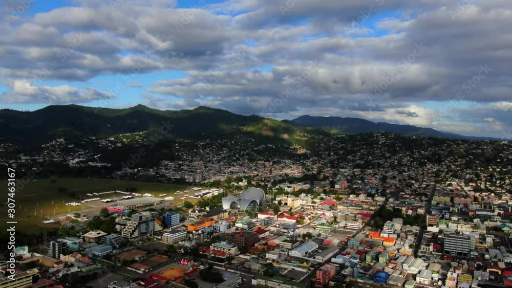 Aerial view of city Port of Spain in Trinidad, background of civil and government buildings, hippodrome racetrack. Beautiful mountain and sky. Capital of Trinidad and Tobago