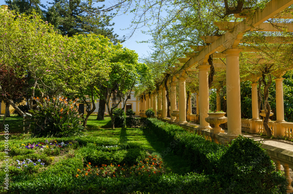 Portuguese garden with flowers and Greek style columns