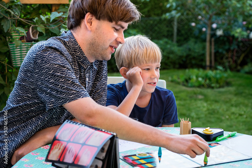 Father and son playing board game photo