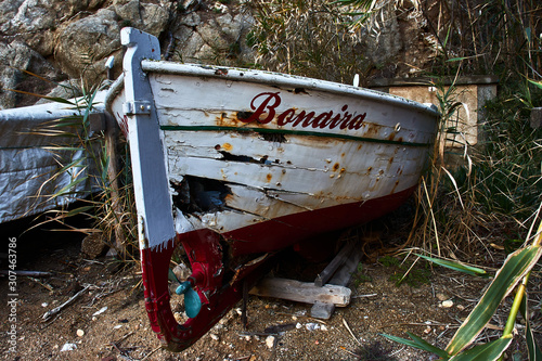Old battered boat, stranded on the beach