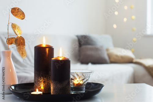 black and golden candles on white table