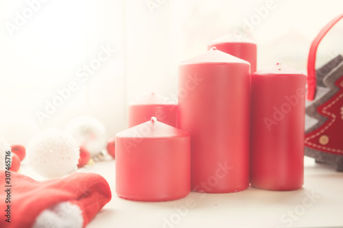 Red Christmas candles and decoration against a window