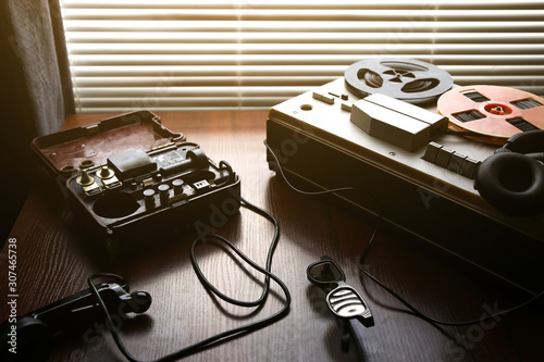 Reel tape recorder for wiretapping. Field telephone set USSR is lying nearby.  KGB spying conversations.