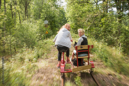 Teenage girls using handcar photo