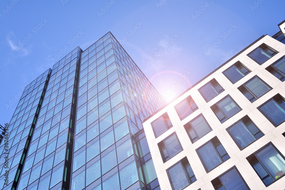 Modern office building detail, glass surface with sunlight. Business background. 