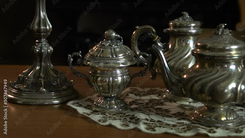 Slowly overview of a silverware tea set near two vintage candle holders FDV Slowly overview of a silverware tea set near two vintage candle holders FDV