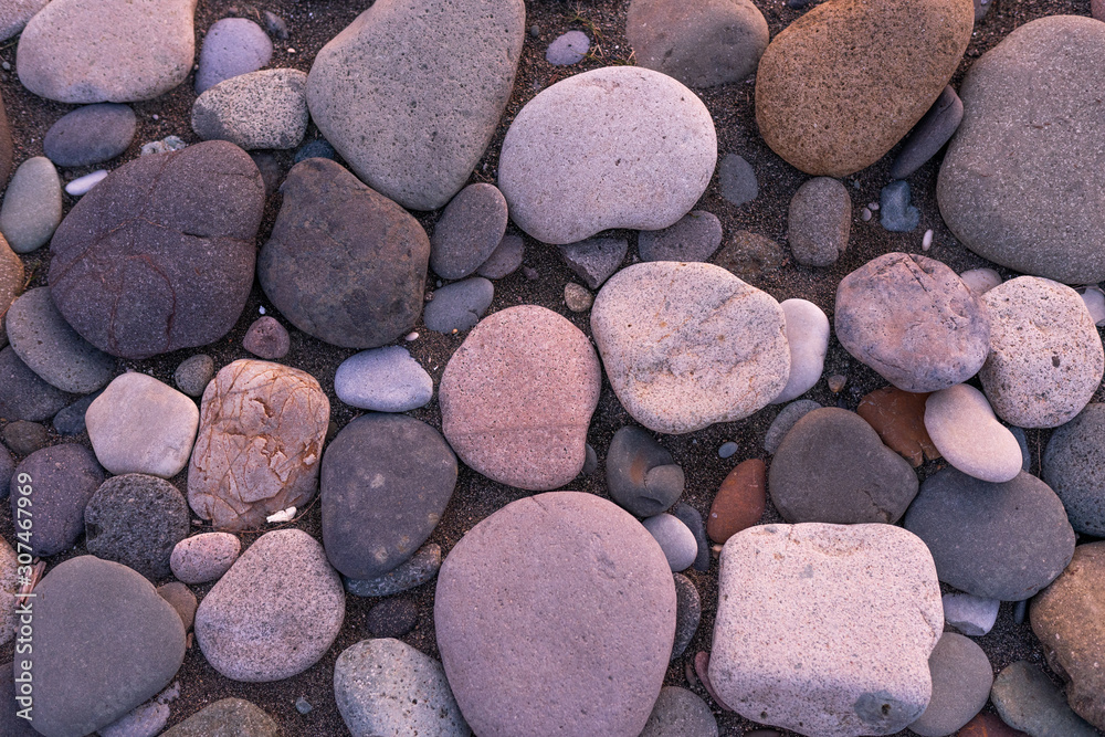 Large pebbles or stones lie on the shore at sunset. Black Sea
