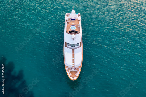 High angle shot of a white luxury yacht on the calm sea © SPIX PRODUCTION