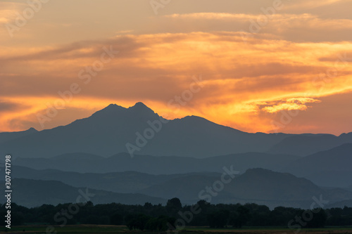 Sunset behind Rocky Mountains range in hazy conditions