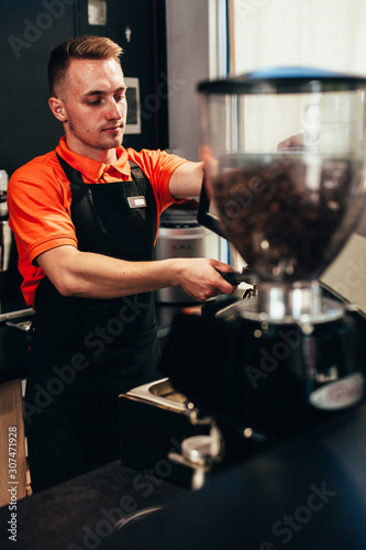 Barista makes delicious coffee in a coffee shop