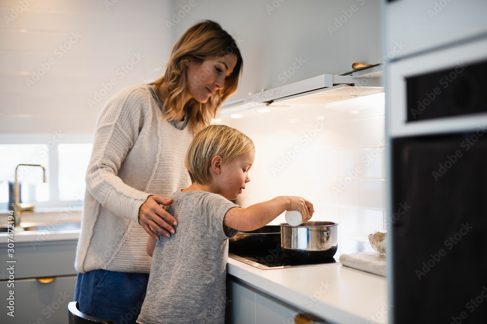 Boy with mother in kitchen Boy with mother in kitchen