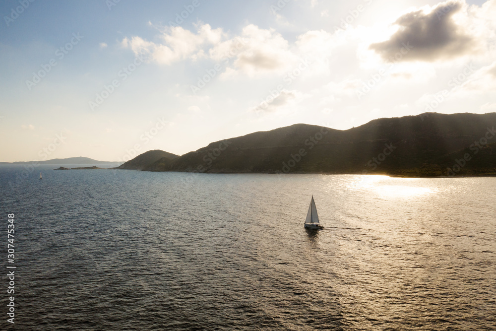 Aerial view of boat sailing along Sardegna coastal line, Italy. Aerial view of boat sailing along Sardegna coastal line, Italy.