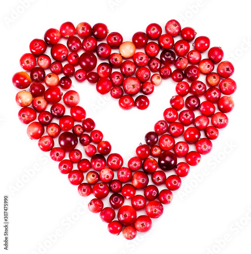 Heart made of ripe cranberries isolated on a white background. Top view.
