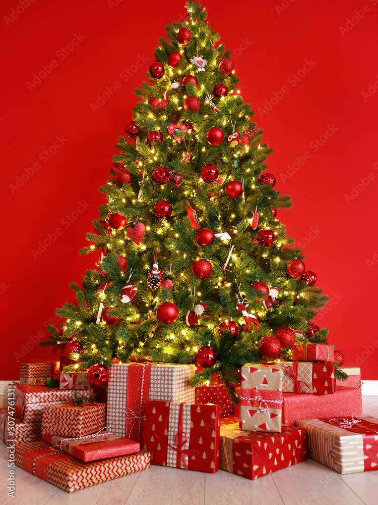 Christmas tree on the background of red empty wall. Christmas tree on the background of red empty wall.