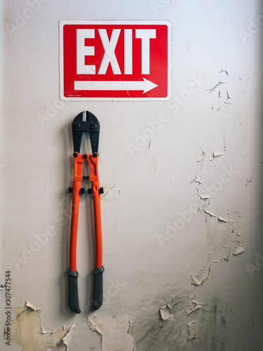 Bolt Cutter Pliers and and Exit Sign photo